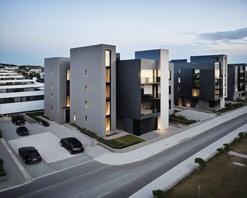 a 5-level minimalistic building with two tall black walls. Generate a neighborhood around it and streets with cars.,two black cars in front of several tall building,residencial,new housing development