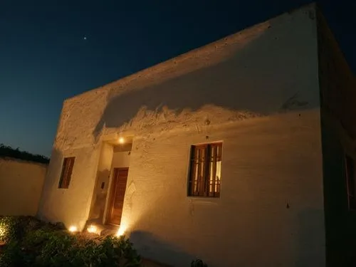 a building with lights on the side and some plants,cortijo,san pedro de atacama,masseria,amorgos,trullo,serifos,Photography,General,Natural