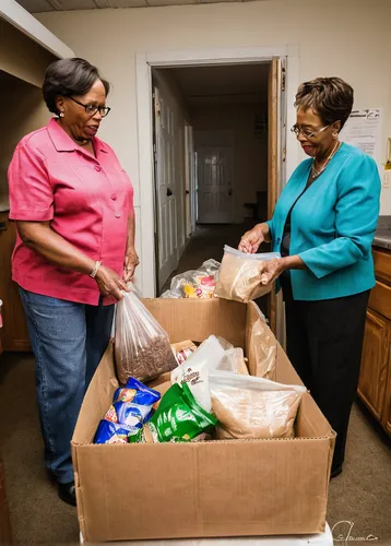 The Rev. Gregory T. Manning, pastor of Gloria Dei Lutheran Church, assists Glenda Gordon (left) and Delores Blanche with bagged food from the Broadmoor Food Pantry next to Gloria Dei on Wednesday, Mar