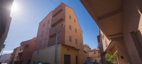 a street view in front of a large brown building,sapienza,zagaria,modena,anzio,urbino,teramo,cagliari,chirico,albenga,pescia,brunelleschi,palazzi,volterra,genoa,panozzo,bologna,miscenco,lucca,borghi,a