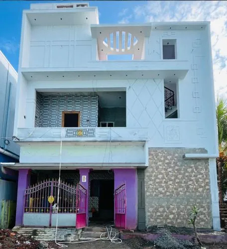 a white building that has some purple doors and railings,papanasam,dhaalu,vishakapatnam,kathiraveli,vilayanur,srikalahasti