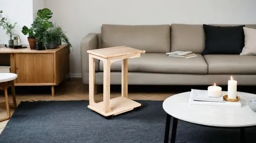 Small coffee table next to the sofa,the living room has a couch, coffee table, and other furniture,danish furniture,anastassiades,small table,folding table,mobilier,wooden table