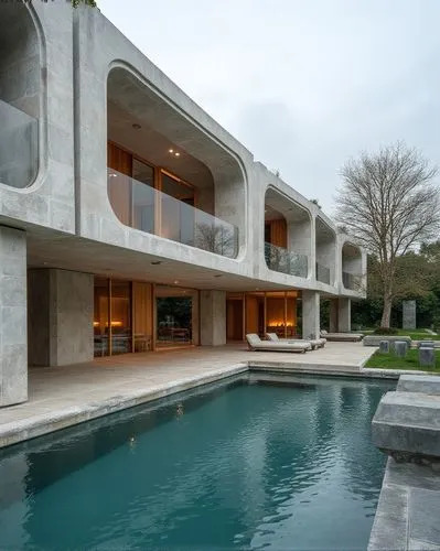  ,an exterior view of a large house with a pool and many glass doors,bridgehampton,dunes house,pool house,luxury property,luxury home,modern house