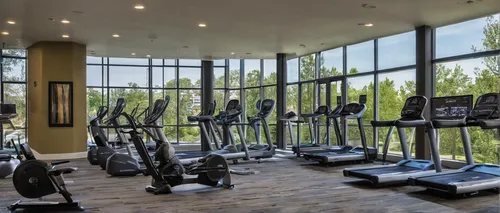 Describe the state-of-the-art fitness facilities at East Perimeter Pointe Apartments.,fitness center,fitness room,leisure facility,exercise equipment,indoor cycling,workout equipment,elliptical traine