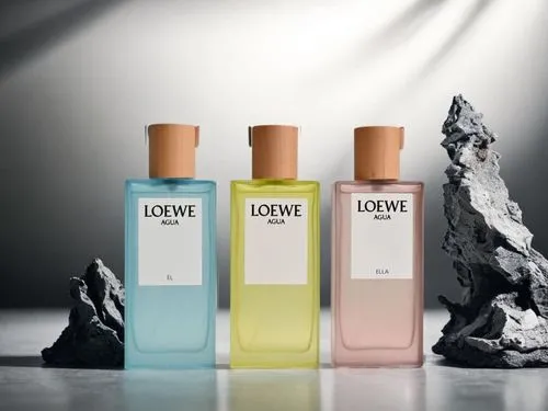 three bottles with two different perfumes one containing liquid and the other containing a rock,loewe,lakme,lotane,lotions,lefauve,lavoine