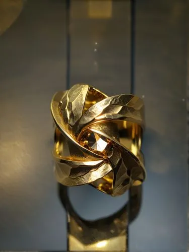 beautiful gold ring from top view, faceted surfaces, shine and matte  gold material ,gold flower,gold foil laurel,golden wreath,laurel wreath,bronze sculpture,gold foil crown,gold bracelet,gold foil c