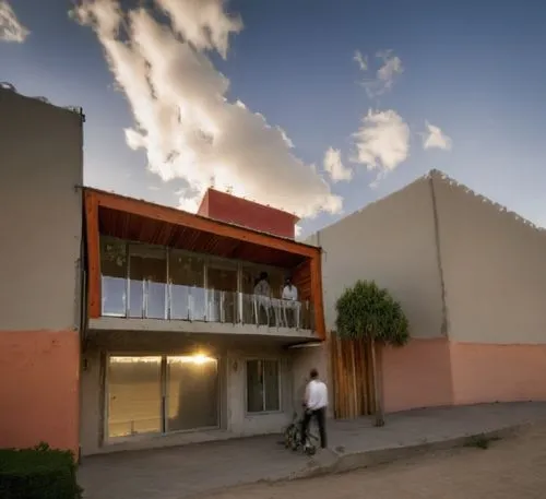 The minimalist style house made of glass and steel and featuring a vibrant painting of the City of Red Square. The house exudes a unique blend of colors, with the iconic colors of Mexican architecture