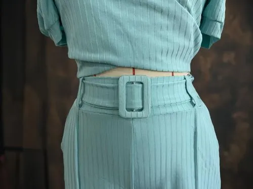 the back of a woman's outfit with a belt,waistbelt,belt with stockings,pleats,reed belt,turquoise leather,waistband