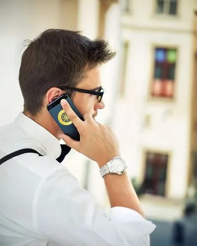 a man in sunglasses and white shirt talking on his cell phone,man talking on the phone,telephone handset,corporatewatch,bluetooth headset,handset,wireless headset