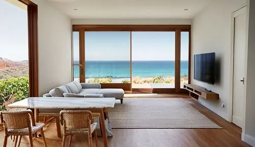 warm tones, cinematic shoot, warm afternoon light, sandstone floor. big glass window overlook seaview. wood colums. light grey sofa . marble table. rattan chairs. tv wood shelf. white walls on left an