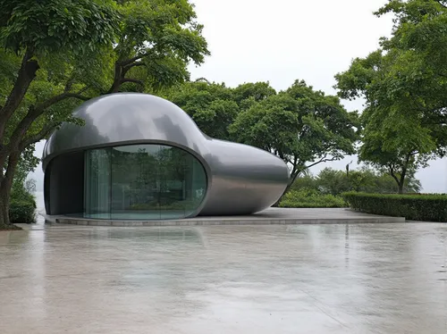 1building,a silver building with glass and curved structure next to trees,k13 submarine memorial park,mirror house,futuristic art museum,kimbell,niemeyer,quadriennale