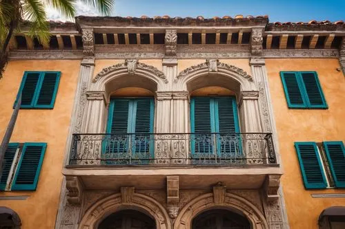 Historic savannah style building, ornate facade, grand entrance, intricate wooden doors, rustic stone walls, clay roof tiles, decorative balconies, vibrant colorful shutters, palm trees surrounding, s