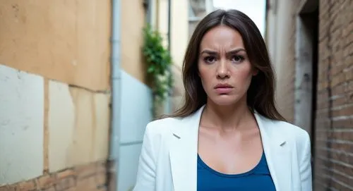 woman frowning and not wearing clothes she is in an alleyway full of criminals,a woman standing near a brick wall looking at the camera,derya,karasev,teledrama,hatice,alsou,yanet