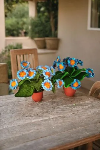 potted flowers,gerbera daisies,garden flowers,flower pot holder,flower vases,zinnias,wooden flower pot,garden bench,tabletop photography,blue daisies,fabric flowers,garden decor,summer still-life,flow