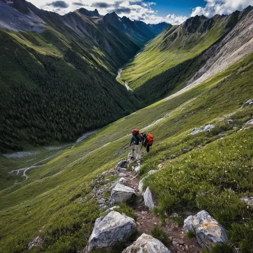 Keith looks back at our route down the west face before we plunge down grassy slopes to the creek below.,alpine crossing,via ferrata,alpine climbing,the descent to the lake,pyrenees,mountain hiking,al