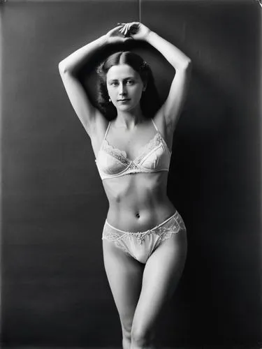 Full-length black-and-white portrait of Queen Olga of Württemberg dancing in a trance and in skimpy underwear. She has never shaved her natural, dark armpit hair or her pubic hair, which is very obvio