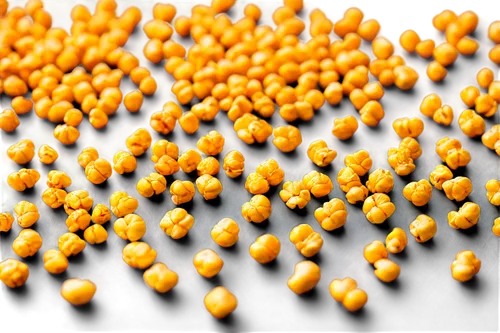 Golden popcorn kernels, scattered on white surface, shallow focus, macro photography, warm lighting, soft shadows, crunchy texture, rounded shapes, dynamic composition, cinematic angle, realistic rend