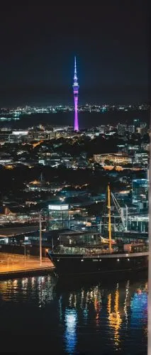 Auckland Film Festival venue, modern architecture, glass building, sleek lines, urban landscape, cityscape, evening atmosphere, warm lighting, people walking in, casual dress, holding tickets, excited