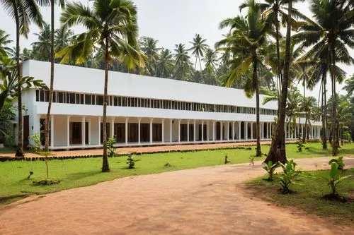 Bishop Jerome School of Architecture and Design, Kollam, Kerala, India, modern building, white walls, large glass windows, sloping roofs, greenery surroundings, tropical trees, coconut palms, lush veg