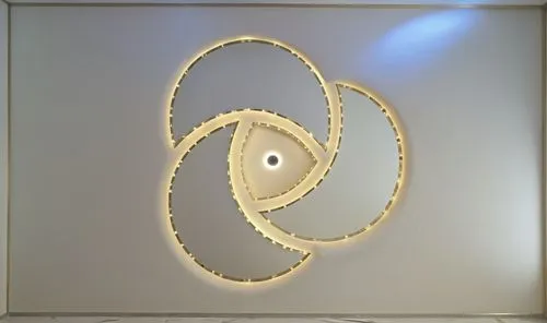 
Gypsum decoration in the ceiling of a room with hidden LED lighting,a white room with a round light hanging on the wall,wall lamp,wall light,circle shape frame,foscarini,penannular,circular ornament,