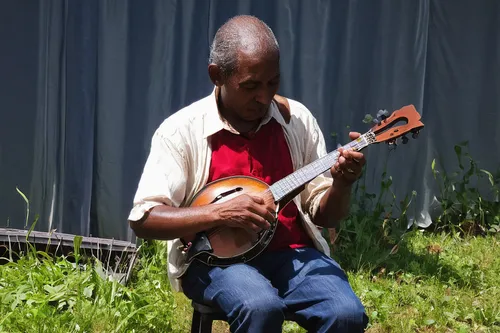 "Man Playing Mandolin (from ""Family of Man"")",itinerant musician,cavaquinho,dulcimer,violin player,string instrument,plucked string instrument,bowed string instrument,stringed instrument,banjo playe