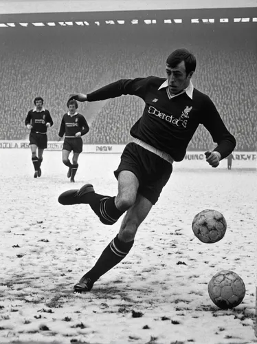 Liverpool v Nottingham Forest on 15th February 1969: Ian St. John clears the ball but instead kicks it into a flurry of snow,a ball in the snow,white turf,southampton,winter sport,beach soccer,leningr