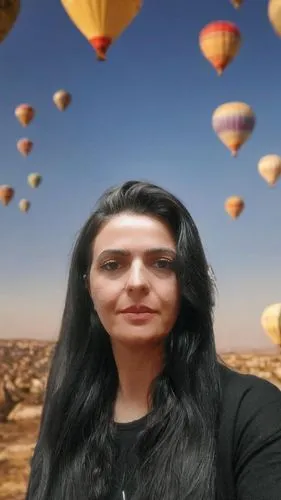 a woman with long black hair in a black shirt looks directly into the distance as many balloons fly overhead,marzieh,numaniyah,greenscreen,sukhteh,kedumim,zarrineh,merani,mahli,masoumeh,3d albhabet,se