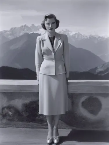 A lady from the 1940s in front of an Alpine backdrop.,a woman standing on top of a balcony,watzmannfrau,mitford,stanwyck,matruschka,malaparte,magnani,Photography,Black and white photography,Black and 