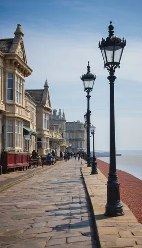 Weston-super-Mare, seaside town, British architectural style, Victorian-era buildings, Grand Pier, sandy beach, low-tide, sailboats, seagulls flying overhead, cloudy blue sky, soft natural light, warm