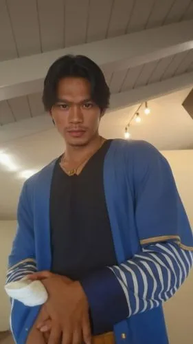 Filipino looking  handsome,a guy holds a small white object in his hand,sportacus,qaddafi,freden,kodjoe,ghadafi,kronk,klump,baljeet,mulato,gotoku,dijk,raj,gaddafi,jermaine,kazama,nudelman,bodian,kazuy