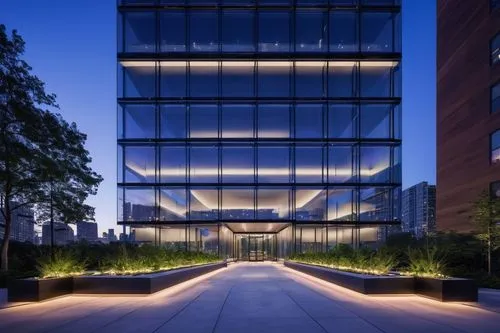 Modern Jacobsen Architecture LLC building, sleek glass façade, minimalist steel structure, urban skyscraper, cityscape background, blue hour ambient lighting, low-angle shot, strong geometric shapes, 