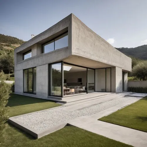 It is a modern single-story house of about 100 square meters, with large open windows at the front, exposed concrete-finished walls, and grassed grounds in the front yard,modern house,dunes house,cubi