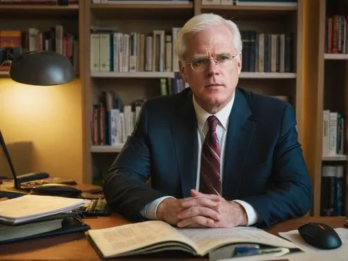 John Hennessy, mature man, glasses, white hair, formal wear, suit, tie, white shirt, sitting, desk, computer, keyboard, mouse, papers, books, shelves, office, Stanford University, warm lighting, soft 