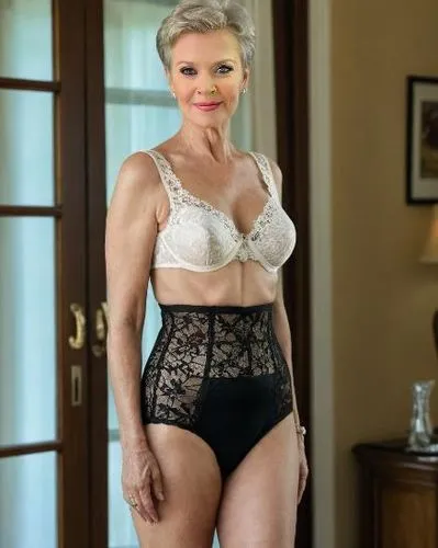 65yo  milf, short hair, wearing lace pantygirdle, happy,a woman in lacy lingerie standing by a door,khorkina,kolinda,laurentien,shapewear,beverlee,vintage lace