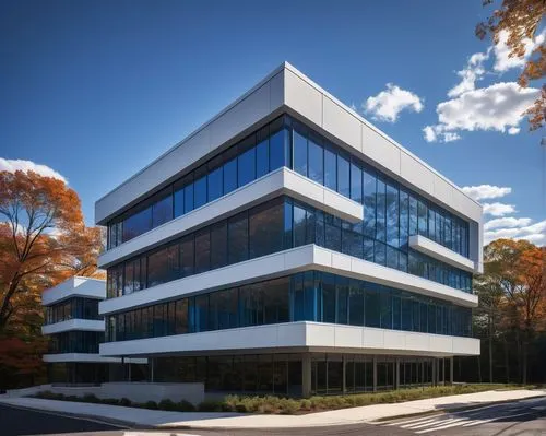 Modern Chappaqua CSD RFP 2019 building, futuristic architecture, sleek lines, glass façade, steel frames, cantilevered roof, urban landscape, cityscape, blue skies, fluffy white clouds, low-angle shot