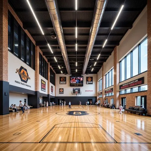 Modern gymnasium interior, polished wooden floors, motivational quotes, athletic logo designs, exposed ductwork ceilings, industrial-style lighting fixtures, sleek metal beams, vibrant color accents, 