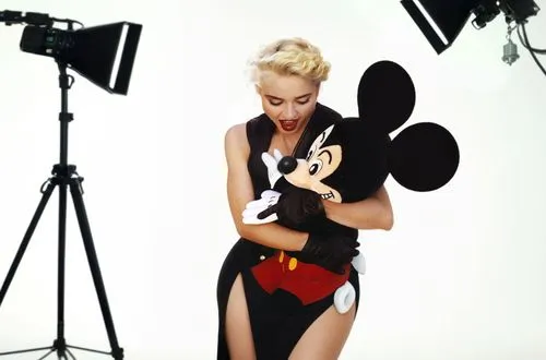 woman in black and red outfit holding mickey mouse,the blonde photographer,minnie mouse,video scene,madonna