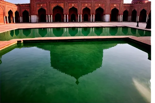 Badshahi Mosque, Lahore, Pakistan, Mughal Empire architecture, grand entrance, large dome, four minarets, intricate marble inlays, golden decorations, reflective water pool, beautiful arches, Islamic 