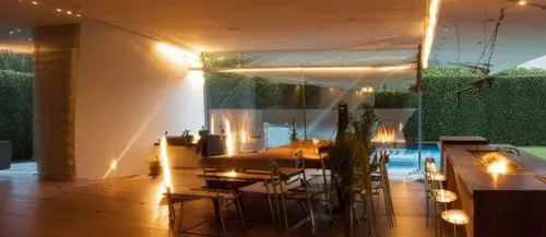 INTERIOR DE UN COMEDOR CON UNA ISLA CON ESTUFA TERMOMAGNETICA, CON UN GRAN VENTANAL A UN JARDIN EXUBERANTE, LUMINARIAS MODERNAS, PERSONAS,a large table sitting in a room with lots of lights,landscape 