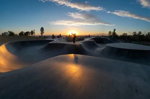 a skateboarder riding up an incline at a skate park,half pipe,halfpipe,fullpipe,skatepark,quarterpipe,superpipe