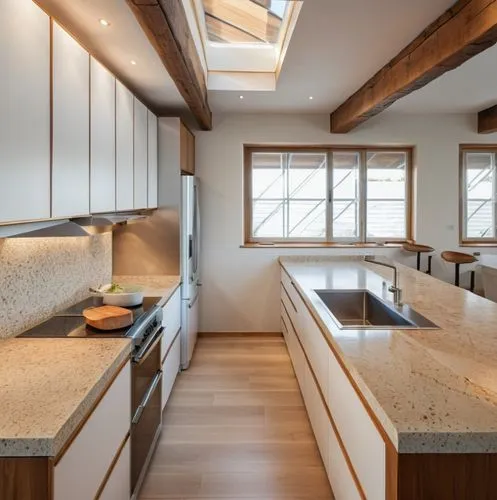 Contemporary kitchen with skylight, apparent structural beams, wooden floor, white coloured countertops made of natural stone, ,a modern kitchen is shown with high counter top and wooden beams,modern 