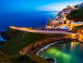 a beach at night with houses on the coast,gaztelugatxe,italy liguria,calabrian,tropea,calabria,sicilia