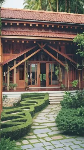 a symmetrical pitched roof kerala house, central entance with main door, either sides big glazed window, with front portion a pitched roof and either side higher roof pitched.  roof with mangalore til