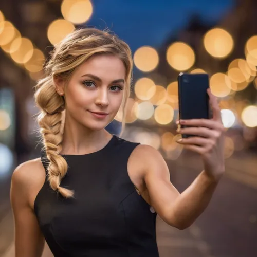 Scene of a girl with curly hair in France,a beautiful woman holding a smart phone in her hand,girl making selfie,woman holding a smartphone,blonde girl with christmas gift,mobitel,blonde woman,photo s