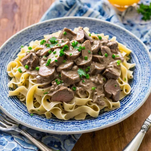 Slow Cooker Beef Stroganoff - A classic recipe made with a creamy mushroom sauce, steak and served over a bed of tender egg noodles. A family favorite!,beef stroganoff,tagliatelle,fettuccine alfredo,c