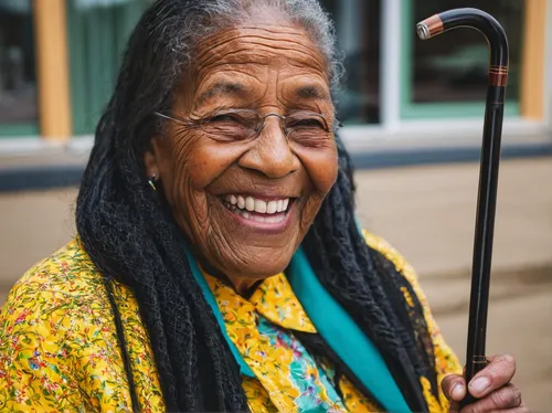 Resident smiling with a cane at Harmony at Enterprise in Bowie, Maryland,care for the elderly,elderly lady,elderly person,nursing home,older person,elderly people,respect the elderly,old woman,pension