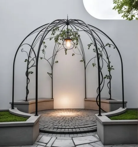 Exterior. Rotunda made of forged black metal, square in shape. Climbing forged plant. Black forged metal climbing plants. The base of the flowerbed is made of clinker brick. The floor is paved with pa