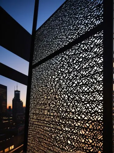 Modern architectural metal screen, intricate laser-cut design, silver coated aluminum, geometric patterns, ornate details, natural light filtering through, subtle shadows, urban cityscape background, 