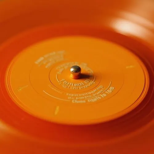 a close up of an orange record disk,vinyl record,orange,discs vinyl,long playing record,33 rpm,golden record