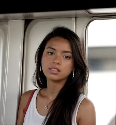 She is in the train car and the car is full of people.  She wears white sneakers and a light summer dress.  Blurred background appearance.,amerie,marshallese,janel,filipina,laotian,mayhle,cambodian,ca